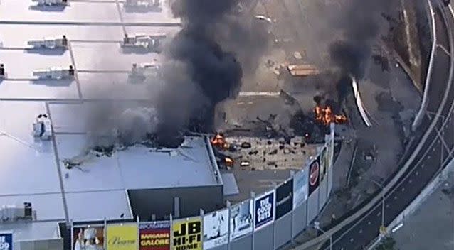 The plane rolled when it hit the Essendon DFO shopping centre roof before skidding off and crashing into a car park, the report revealed. Picture: 7 News