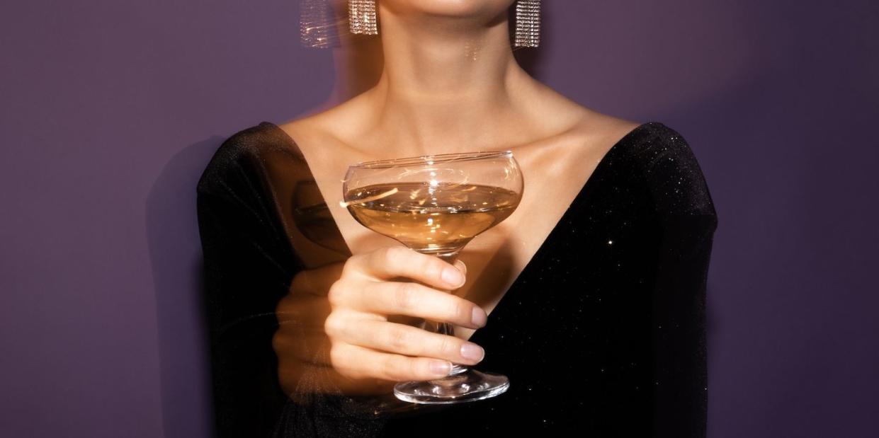 a woman holding a glass of wine