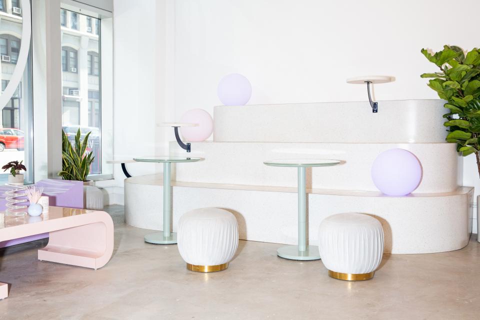 Pleated poufs serve as playful seating. The dusty mint bistro tables are a subtle and wonderful touch, too.