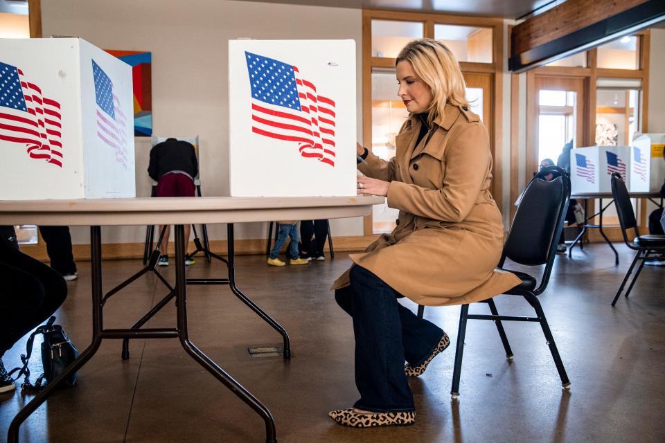 Iowa Republican U.S. Rep. Ashley Hinson fills out her ballot at the Lowe Park Arts and Environment Center in Marion, Iowa, on Tuesday, Nov.  8, 2022.