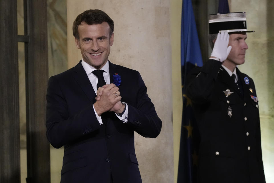 FILE - French President Emmanuel Macron appears on the steps of the Elysee Palace in Paris, Nov. 11, 2022, before a dinner at the Elysee Palace to close the Peace Forum event. Emmanuel Macron is hosting Tuesday Dec. 13, 2022, in Paris an international conference meant to help Ukraine make it through winter. On the longer term, he insists talks with Russia will be needed to find a path to peace. (AP Photo/Christophe Ena, File)