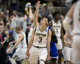 Wofford guard Fletcher Magee (3) celebrates with teammates after hitting a 3-point basket during the final moments of the second half against Seton Hall in a first-round game in the NCAA men’s college basketball tournament in Jacksonville, Fla. Thursday, March 21, 2019. (AP Photo/Stephen B. Morton)