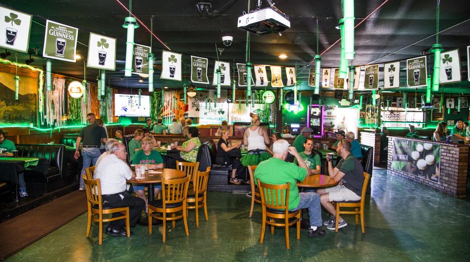 People celebrate St. Patick's Day at the Dubliner Irish Pub and Restaurant in Phoenix, Friday, March 17, 2017.