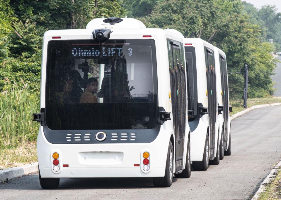 Passengers ride on a  Ohmio Lift autonomous vehicle, which the Port Authority of New York & New Jersey demonstrated at John F. Kennedy International Airport June 8, 2023. The Port Authority demonstrated three vehicles, which could be used to ferry airport passengers from parking lots to the AirTrain or around the airport campus. 