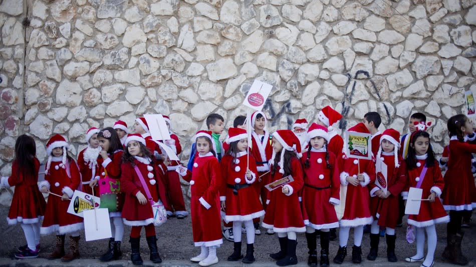 Children take part in the annual Christmas Eve parade in Nazareth (Ariel Schalit/Rex/Shutterstock)