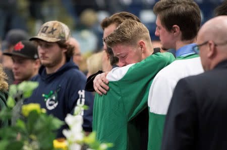 Mourners comfort each other during a vigil at the Elgar Petersen Arena, home of the Humboldt Broncos, to honour the victims of a fatal bus accident in Humboldt, Saskatchewan, Canada April 8, 2018. Jonathan Hayward/Pool via REUTERS