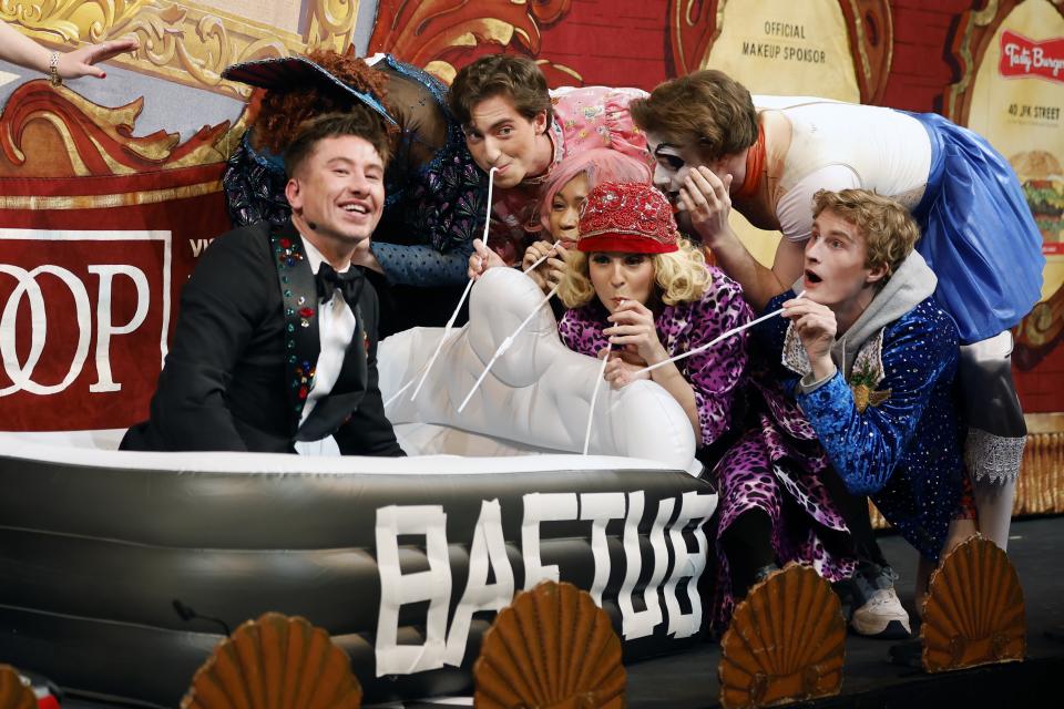 Harvard University's Hasty Pudding Theatricals Man of the Year Barry Keoghan, left, reacts while being presented with a BAFTUB award during a roast, Friday, Feb. 2, 2024, in Cambridge, Mass. (AP Photo/Michael Dwyer)