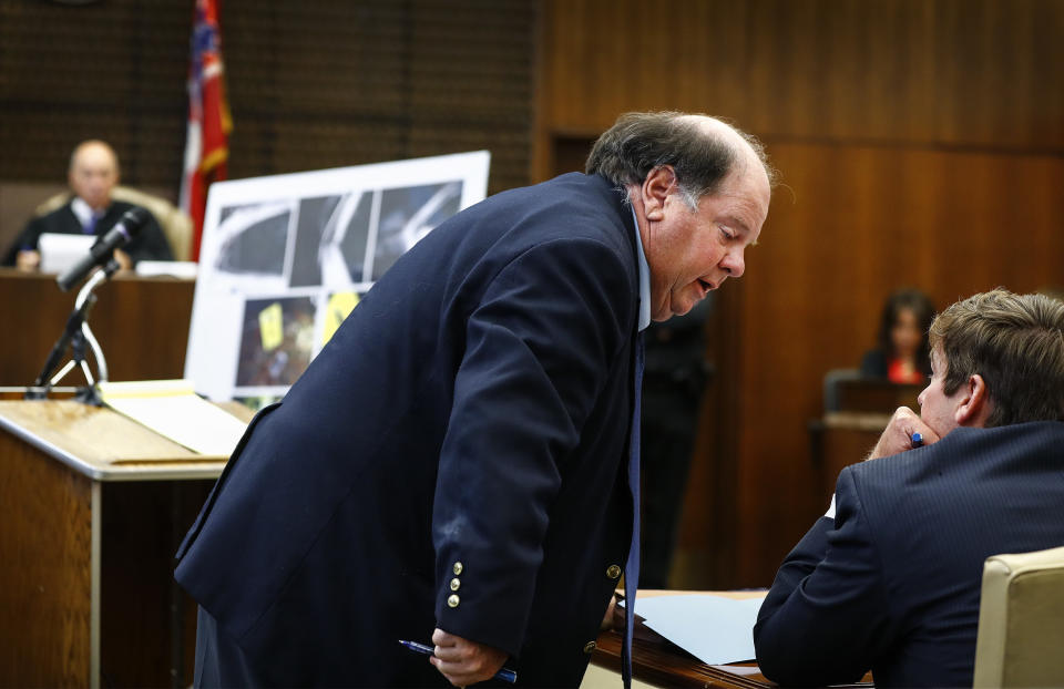 Lead prosecutor John Champion speaks to a colleague on the second day of the retrial of Quinton Tellis in Batesville, Mississippi on Wednesday, Sept. 26. 2018. Tellis is charged with burning 19-year-old Jessica Chambers to death almost three years ago on Dec. 6, 2014. He has pleaded not guilty to the murder. (Mark Weber/The Commercial Appeal via AP, Pool)