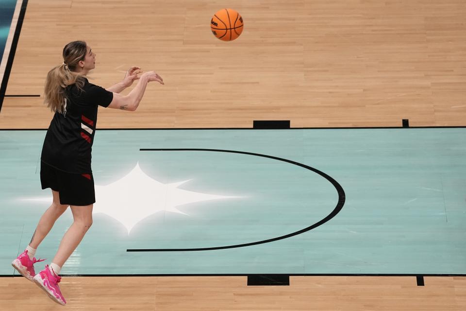 Louisville's Emily Engstler passes during a practice session for a college basketball game in the semifinal round of the Women's Final Four NCAA tournament Thursday, March 31, 2022, in Minneapolis. (AP Photo/Eric Gay)