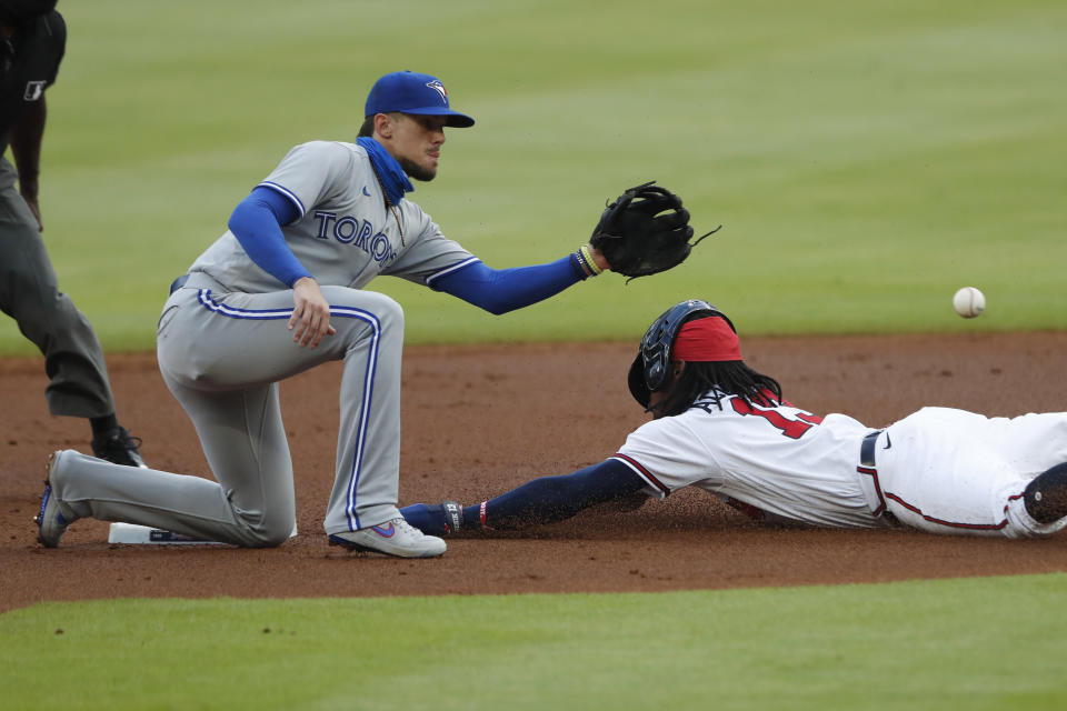 Atlanta Braves' Ronald Acuna Jr. (13) steals second base ahead of the throw to Toronto Blue Jays second baseman Cavan Biggio (8) in the first inning of a baseball game Tuesday, Aug. 4, 2020, in Atlanta. (AP Photo/John Bazemore)