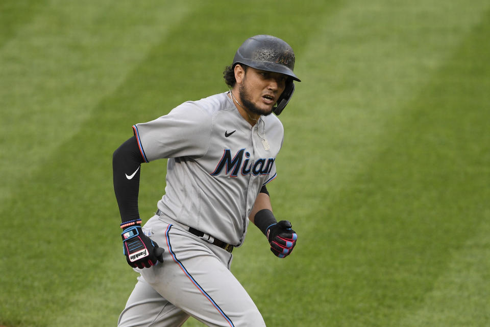 FILE - Miami Marlins' Miguel Rojas reacts as he rounds the bases on his three-run home run during a baseball game against the Washington Nationals in Washington, in this Friday, Aug. 21, 2020, file photo. Rojas has been with the Marlins since 2015, longer than any other player. He's a perfect fit for a small-budget team because he's an overachiever, and thus a sound investment. (AP Photo/Nick Wass, File)