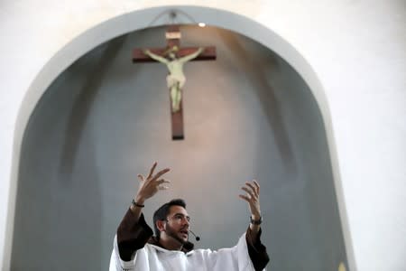 Venezuelan priest Luis Antonio Salazar gestures while talking to devotees during a Sunday Mass at Chiquinquira Catholic church in Caracas