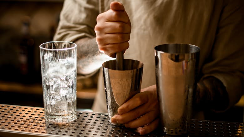 Bartender using a cocktail muddler