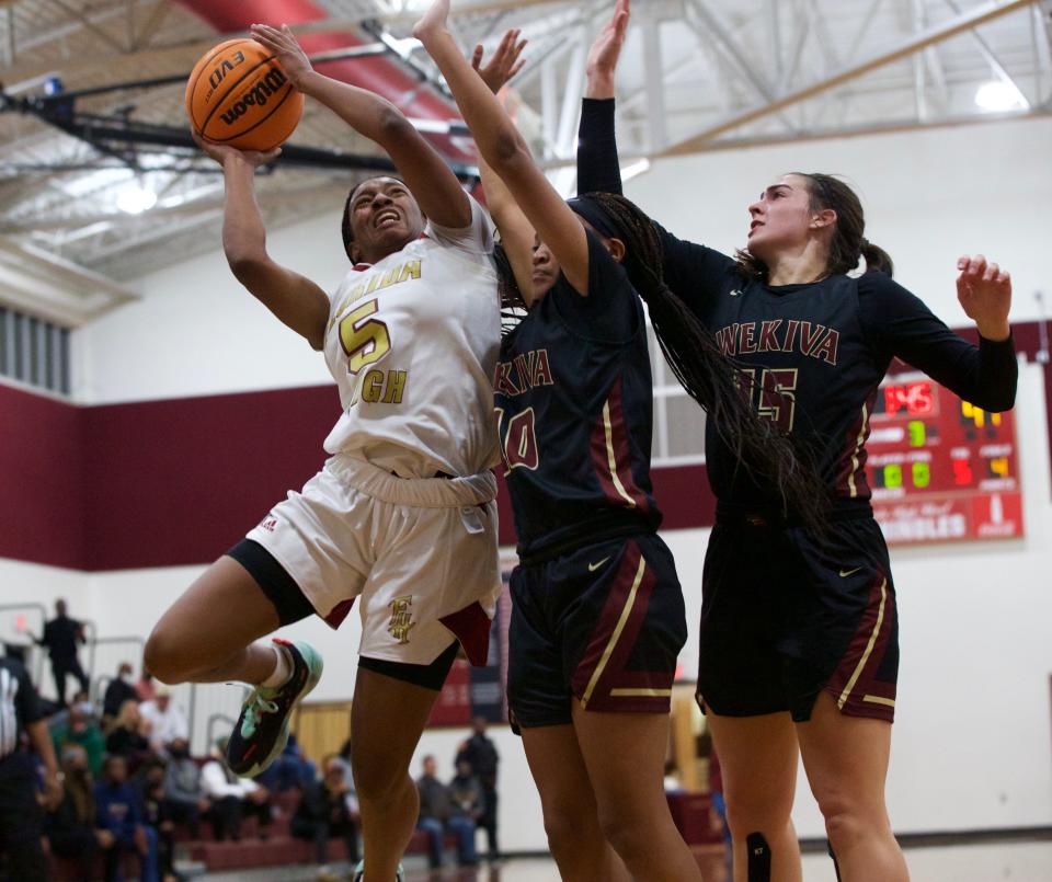 Florida High senior guard Tonie Morgan (5) fights off two Wekiva defenders in a game against Wekiva on Jan. 21, 2022 at Florida High. The Seminoles won, 55-45.