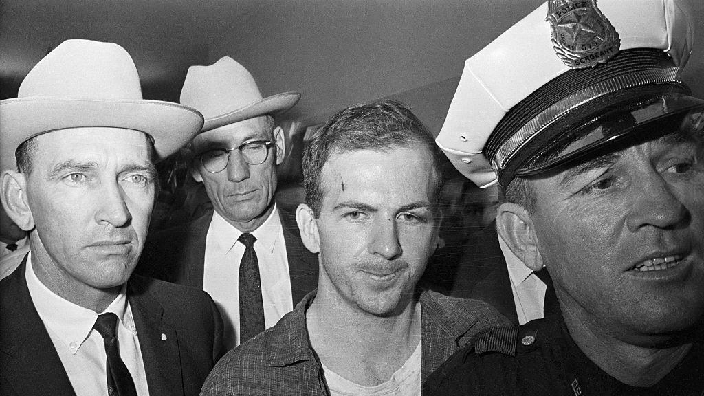 lee harvey oswald being led by policemen