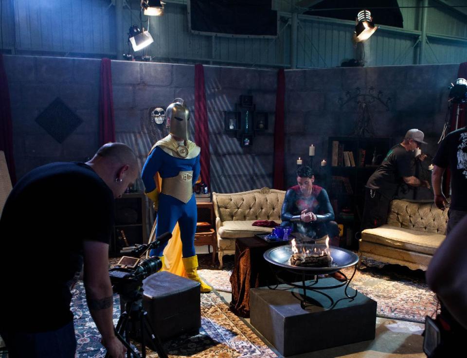 This undated photo provided by Vivid Entertainment Group shows Ryan Driller, seated center, portraying Superman on the set "Man of Steel XXX: A Porn Parody" in Los Angeles. The film, released three years ago, became the biggest-selling porn movie of the year and inspired a seemingly endless succession of imitators starring the likes of Superman, Spider-Man, Ironman, The Incredible Hulk and Wonder Woman. (AP Photo/Vivid Entertainment Group)