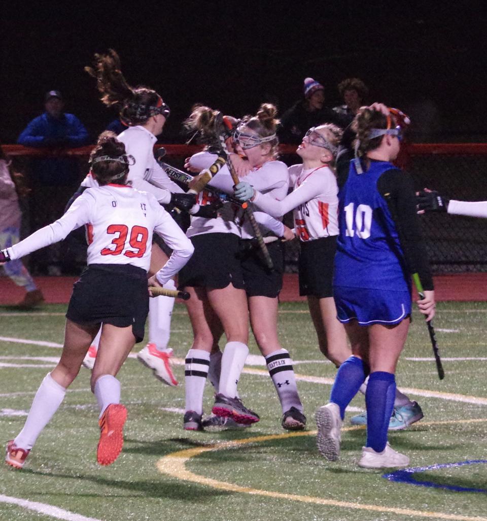 Thursday, Nov. 4, 2021 -- Oliver Ames Tigers surround Ava Costello as she just scored a goal to tie the playoff game with the Scituate Sailors at one midway through the fourth quarter.