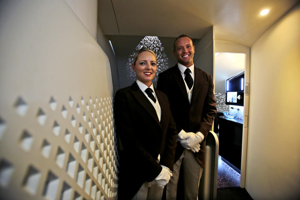 Etihad Airways butlers pose for a photograph, at a training facility in Abu Dhabi, United Arab Emirates, Sunday, May 4, 2014. Etihad Airways, a fast-growing Mideast carrier, laid out plans Sunday to offer passengers who find first-class seats a bit too tight a miniature suite featuring a closed-off bedroom, private bathroom and a dedicated butler. (AP Photo/Kamran Jebreili)