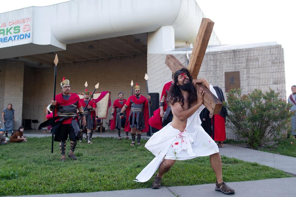 Jesus Christ, played by Rich Lockhart, carries the cross during the 77th Easter Sunrise Passion Play at Cole Park on Sunday, April 21, 2019.
