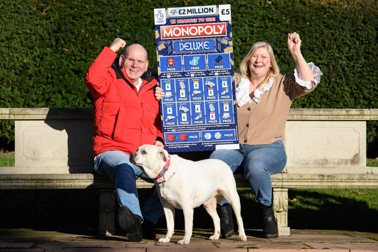 Ian and Sandra with their dog Meg. The couple say the first thing they do with their winnings is pay for Meg's operation. Undated image from Oli Scarff/Camelot