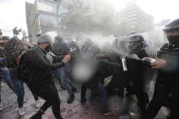 Demonstrators clash with riot police during a march supporting abortion rights in Mexico City, Monday, Sept. 28, 2020. (AP Photo/Marco Ugarte)