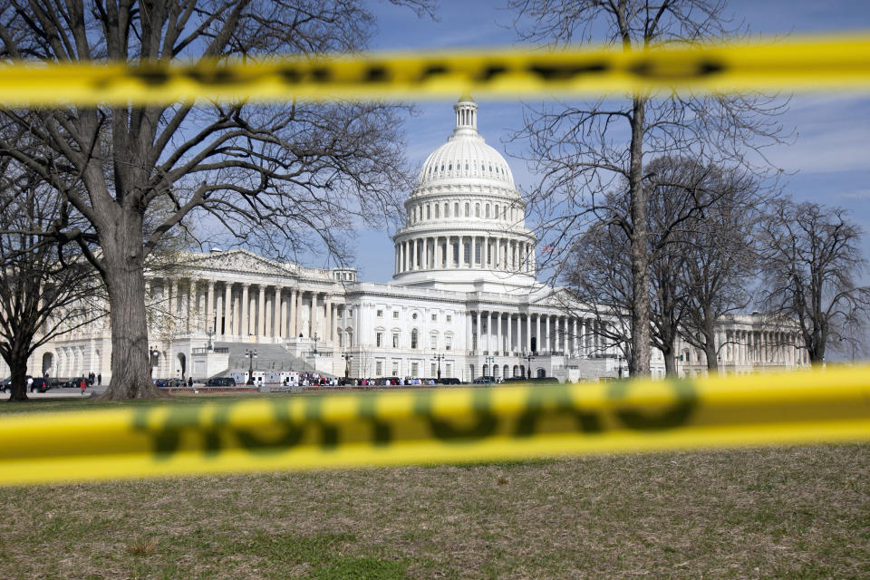 The Capitol building stands behind caution tape