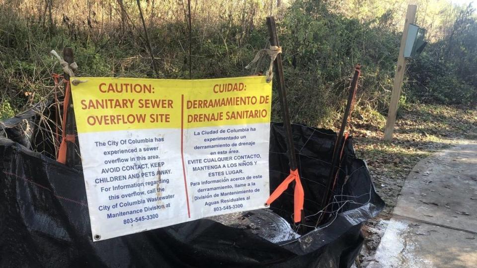 This file photo shows a sign warning about a sewer spill near the Saluda River.