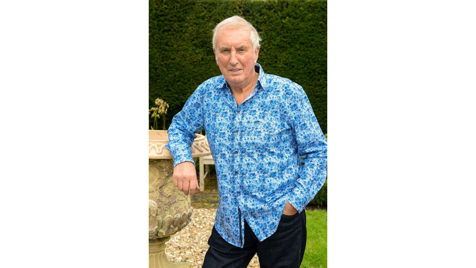 Johnnie Walker wearing a blue shirt in his garden