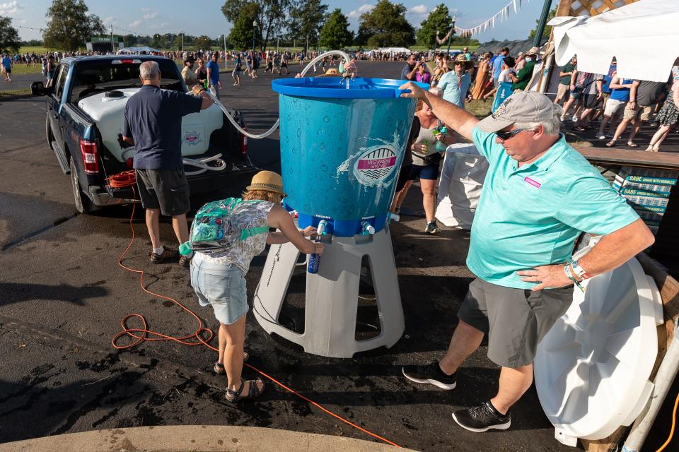 A tank of drinking water is filled up during the Railbird music festival at Keeneland on Sunday, Aug. 29, 2021, in Lexington, Kentucky.