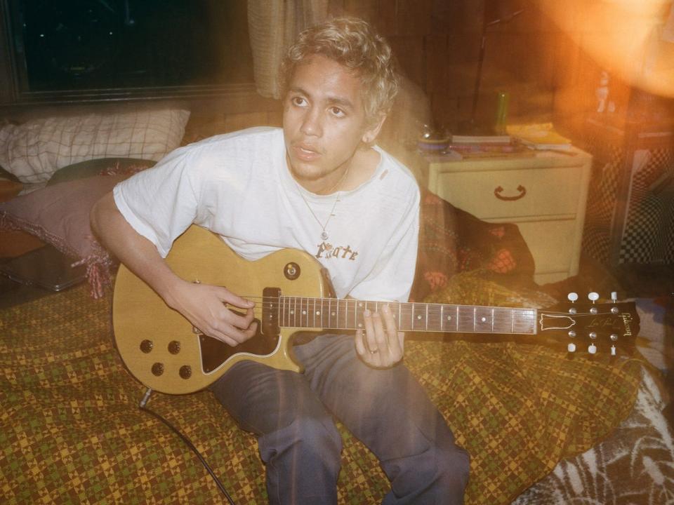 Dominic Fike playing guitar as Elliot on season two of "Euphoria."