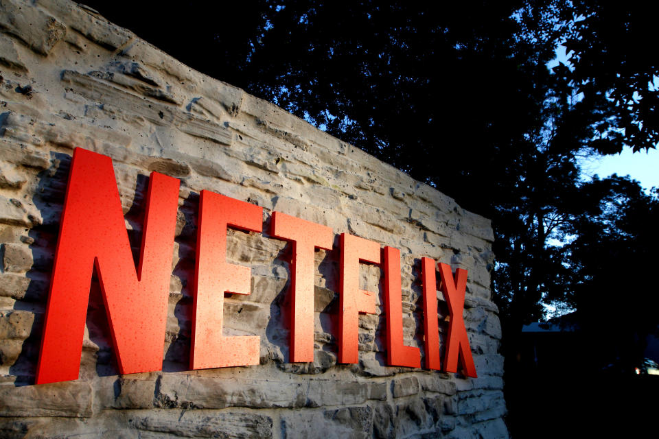 Red Netflix logo on a stone wall, viewed askew.