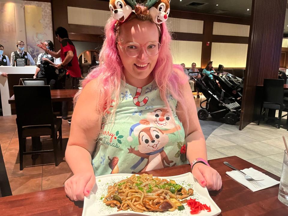 The author sits in front of a plate of udon noodles