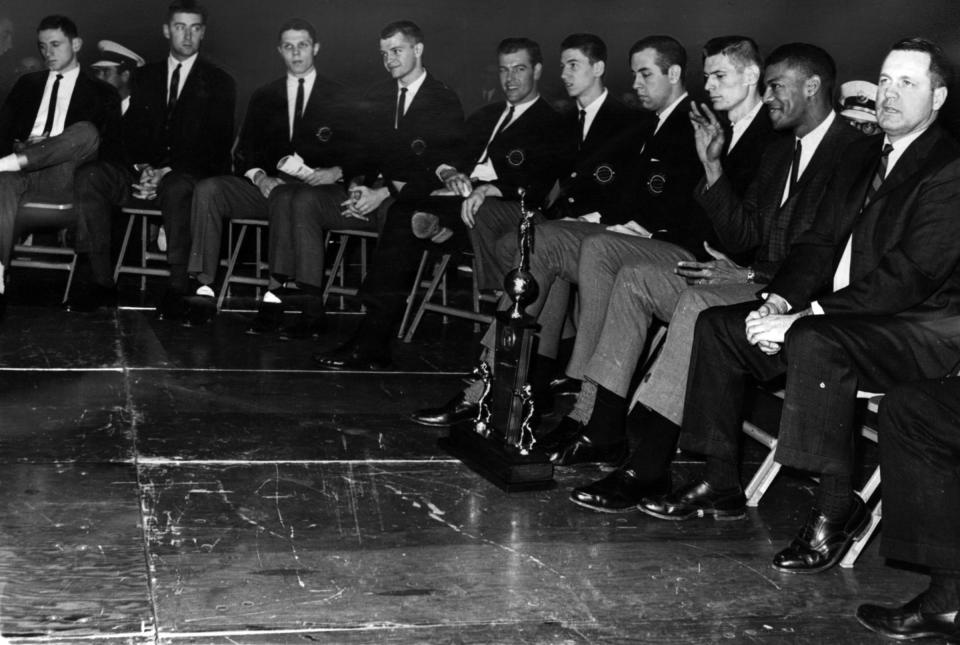 March 25, 1963: The UC Men's Basketball team poses with their runner-up trophy from the NCAA Division I Men's Basketball Tournament. From Left: Larry Shingleton, Coach John Powless, Ken Cunningham, Larry Elsasser, Ron Bonham, Fritz Meyer, Gene Smith, Dale Heidotting, Tony Yates, and Coach Ed Jucker.