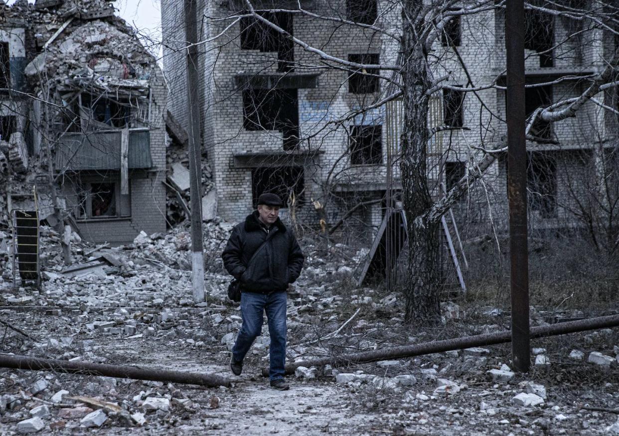 A man walks amid buildings damaged by Russian missiles in Ukraine on Nov. 28, 2022. <a href="https://www.gettyimages.com/detail/news-photo/man-walks-amid-damaged-buildings-hit-by-russian-missiles-as-news-photo/1245195389?phrase=%20ukraine%20soldiers%20winter&adppopup=true" rel="nofollow noopener" target="_blank" data-ylk="slk:Metin Aktas/Anadolu Agency via Getty Images;elm:context_link;itc:0;sec:content-canvas" class="link ">Metin Aktas/Anadolu Agency via Getty Images</a>