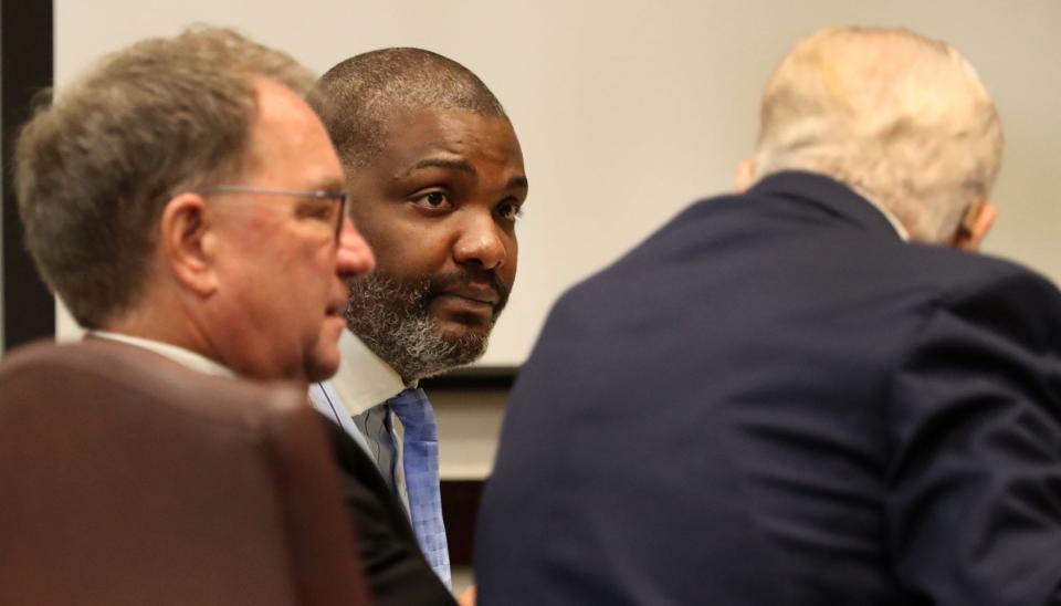 Accused serial killer Robet Hayes talks with his attorneys Chris Anderson and Francis Shea, Friday, Feb. 11, 2022, as his trial begins before Judge Raul Zambrano at the S. James Foxman Justice Center in Daytona Beach.