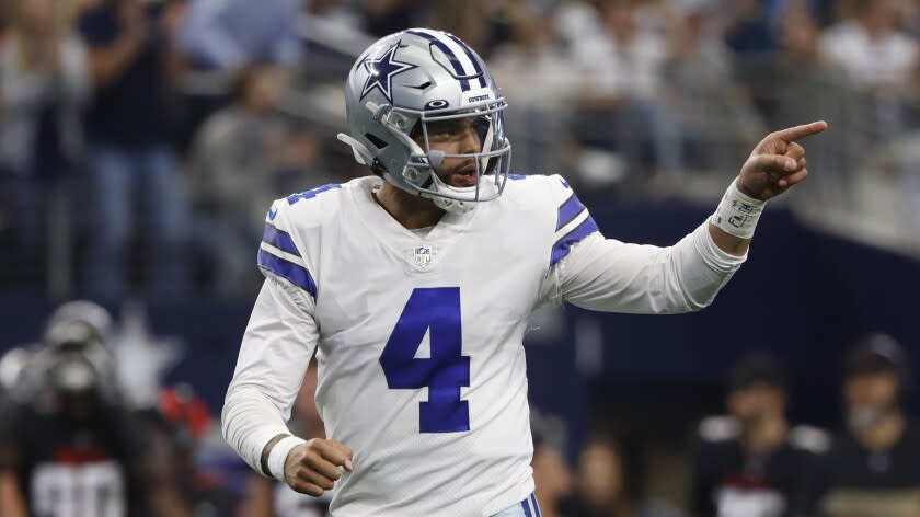 Dallas Cowboys quarterback Dak Prescott (4) reacts after a touchdown against the Atlanta Falcons in an NFL football game in Arlington, Texas, Sunday, Nov, 14, 2021. (AP Photo/Ron Jenkins)