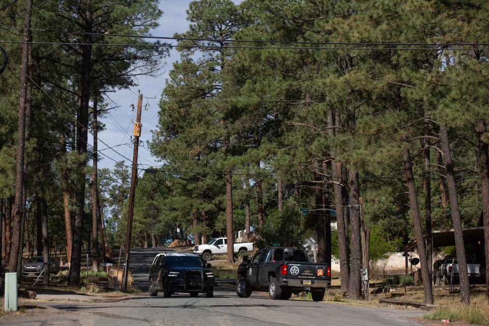 Police officers set up a roadblock near Mechem Drive leading into Cedar Creek to prevent residents and media access on June 24, 2024.