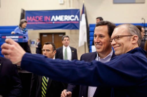 Republican presidential candidate, former US Sen. Rick Santorum (2R) greets supporters and caucus voters during a campaign stop at Westminster Christian Academy in Town and Country, Missouri. Rick Santorum will compete in Missouri's caucus today after winning a non-binding primary held in the state on February 7