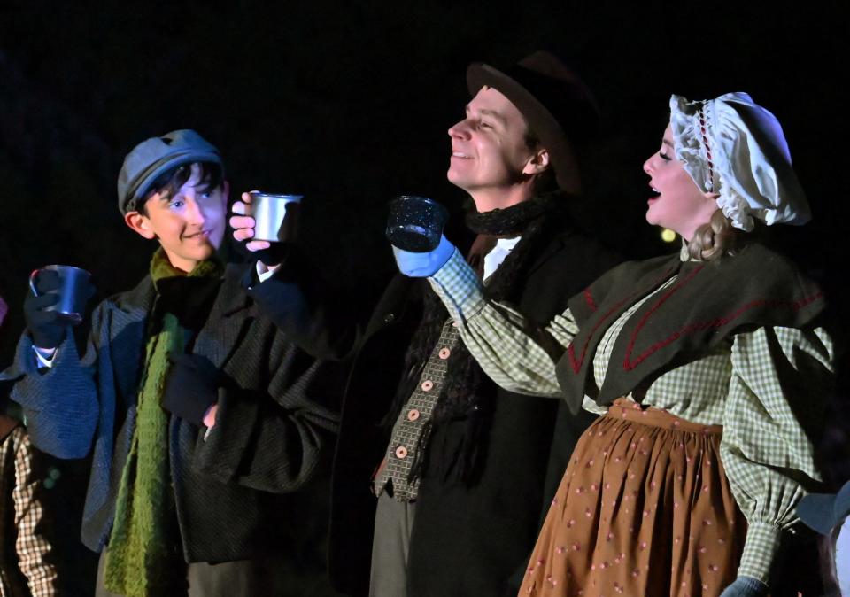 From left, Austin Rindler, Charlie Monnot and Susan Riley play members of the Cratchit family in Lyric Theatre's 2022 production of "A Christmas Carol" at the Harn Homestead.