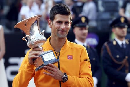 Novak Djokovic of Serbia holds his trophy after winning the final match over Roger Federer of Switzerland at the Rome Open tennis tournament in Rome, Italy, May 17, 2015. REUTERS/Stefano Rellandini