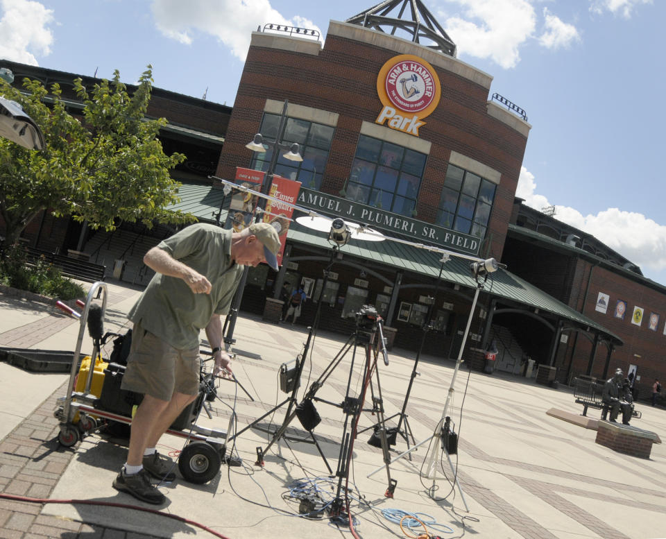 FILE - In this Aug. 4, 2013, file photo, Kevin Trainor, an audio engineer for ESPN, breaks down equipment outside Arm & Hammer Park in Trenton, N.J. Major League Baseball is creating a minor league for top eligible prospects leading to the summer draft., the league announced Monday, Nov. 30, 2020. The founding members of the MLB Draft League are located in Ohio, Pennsylvania, West Virginia and New Jersey: the Mahoning Valley Scrappers, the State College Spikes, the Trenton Thunder, the West Virginia Black Bears and the Williamsport Crosscutters. (AP Photo/Jackie Schear, File)