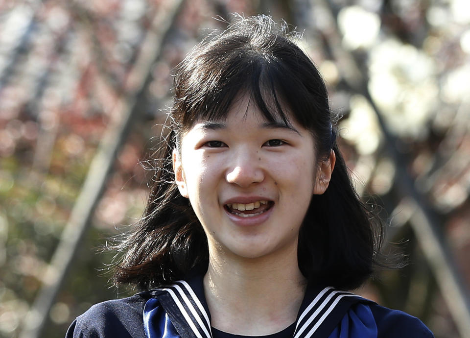 FILE - In this March 22, 2017, file photo, Japan's Princess Aiko, daughter of Crown Prince Naruhito and Crown Princess Masako, smiles as she attends her graduation ceremony at the Gakushuin Girls' Junior High School in Tokyo. Japan’s Emperor Akihito, abdicating Tuesday, April 30, 2019, has a relatively small family, and it will shrink in coming years. (Issei Kato/Pool Photo via AP, File )