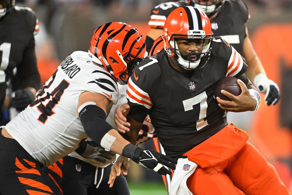 Browns quarterback Jacoby Brissett is tackled by Bengals defensive end Sam Hubbard during the first half in Cleveland, Monday, Oct. 31, 2022.