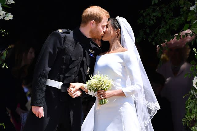 BEN STANSALL/AFP via Getty Images Prince Harry and Meghan Markle kiss at their wedding on May 19, 2018