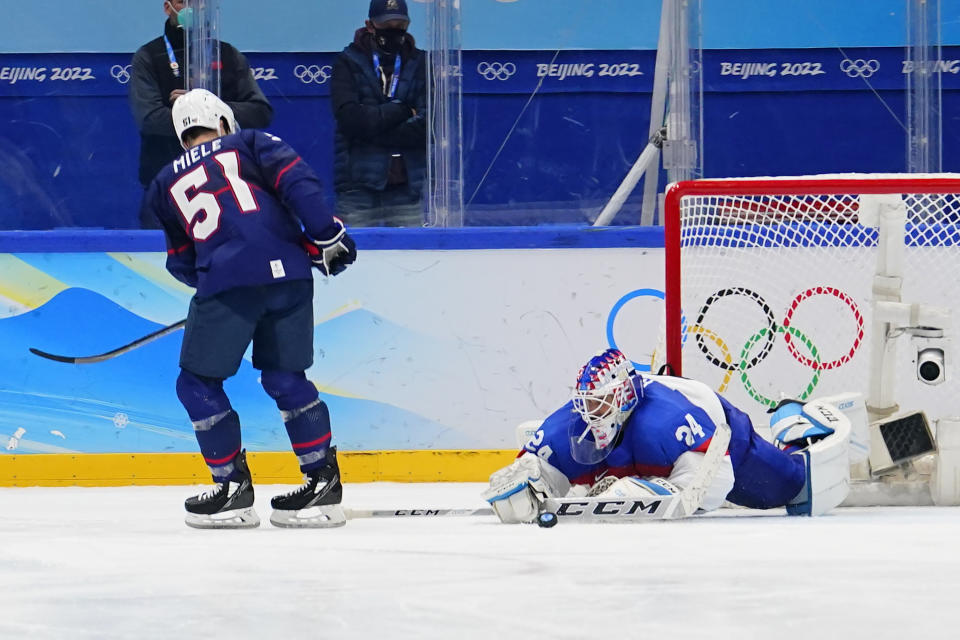 Slovakia goalkeeper Patrik Rybar (24) blocks the final shoot-out attempt by United States' Andy Miele (51) during a men's quarterfinal hockey game at the 2022 Winter Olympics, Wednesday, Feb. 16, 2022, in Beijing. Slovakia won 3-2. (AP Photo/Matt Slocum)