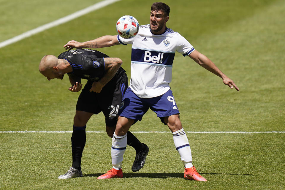 Vancouver Whitecaps forward Lucas Cavallini (9) fouls CF Montréal defender Aljaz Struna (24) in the first half during an MLS soccer game Saturday, May 8, 2021, in Sandy, Utah. (AP Photo/Rick Bowmer)