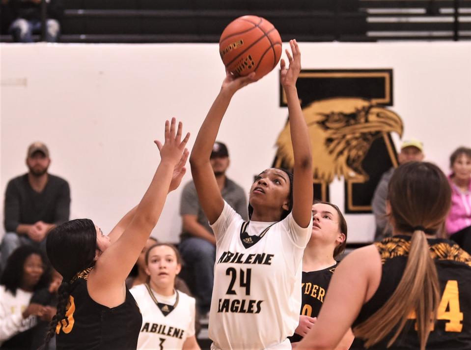 Abilene High's Samara Padgitt (24) shoots over Snyder's Jasmine Hernandez in the first half.