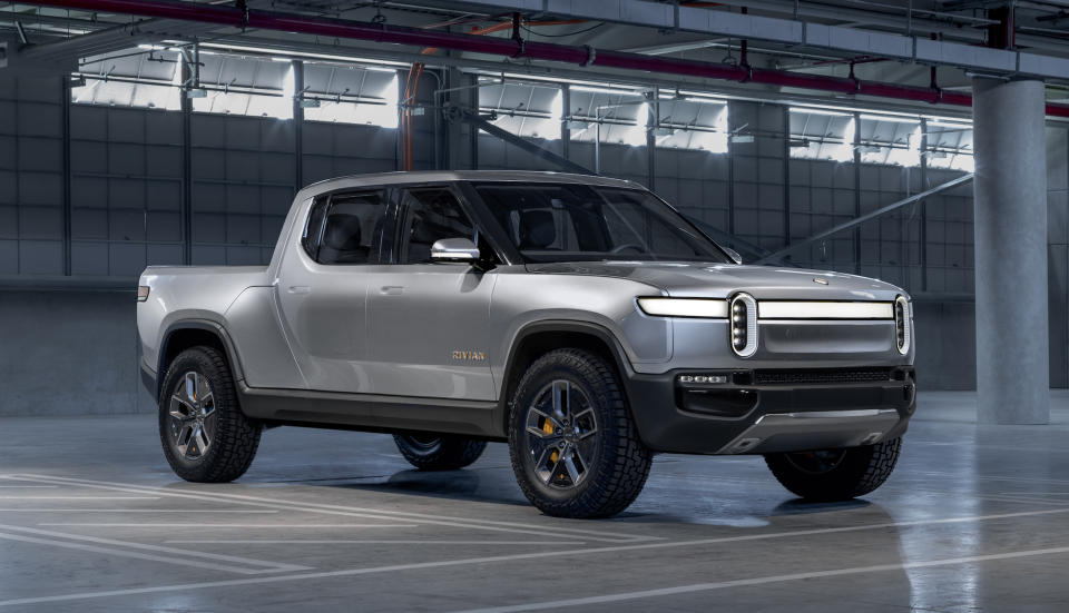 A silver Rivian R1T, a futuristic-looking full-size pickup truck.