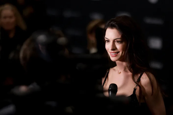 Anne Hathaway is interviewed with a microphone at the premiere of &quot;Eileen&quot; at the Sundance Film Festival.