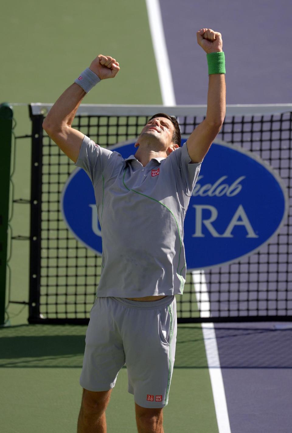 Novak Djokovic, of Serbia, celebrates after winning his semifinal match over John Isner at the BNP Paribas Open tennis tournament, Saturday, March 15, 2014, in Indian Wells, Calif. Djokovic won 7-5, 6-7 (2), 6-1. (AP Photo/Mark J. Terrill)